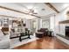 Open-concept living room with wood beams and view to the kitchen with island seating at 42711 N 45Th Dr, Phoenix, AZ 85087