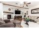 Comfortable living room with a fireplace, wood beams, and large windows providing natural light at 42711 N 45Th Dr, Phoenix, AZ 85087