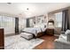 Spacious primary bedroom with hardwood floors, stylish decor, and large windows providing natural light at 42711 N 45Th Dr, Phoenix, AZ 85087