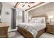 Charming main bedroom features wooden beams, ceiling fan, soft natural light, and neutral color palette at 42711 N 45Th Dr, Phoenix, AZ 85087