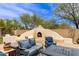 Relaxing outdoor lounge area featuring a custom pizza oven and seating at 42711 N 45Th Dr, Phoenix, AZ 85087