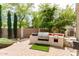 An outdoor kitchen has a grill, counter space, brick pavers, and beautiful landscaping at 42711 N 45Th Dr, Phoenix, AZ 85087