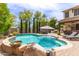 Beautiful backyard pool with fountain feature and lush landscaping at 42711 N 45Th Dr, Phoenix, AZ 85087