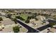 An aerial view of a desert community with homes and green spaces in a well-kept neighborhood at 42760 W Magnolia Rd, Maricopa, AZ 85138