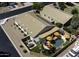 Aerial view of a property featuring a pool, patio, lush landscaping, solar panels, and neighboring homes at 42760 W Magnolia Rd, Maricopa, AZ 85138
