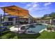 Inviting backyard oasis with a private pool, cozy seating, and lush artificial turf for outdoor enjoyment at 42760 W Magnolia Rd, Maricopa, AZ 85138