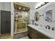 A full bathroom with a shower and a double vanity with a mirror at 42760 W Magnolia Rd, Maricopa, AZ 85138