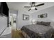 Bedroom with wooden floor, ceiling fan and a mirror on the wall at 42760 W Magnolia Rd, Maricopa, AZ 85138