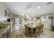 Bright dining area with a dining table, pendant lighting, and a view to the living area at 42760 W Magnolia Rd, Maricopa, AZ 85138
