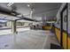 Spacious garage with motorcycle, tools and an opened garage door at 42760 W Magnolia Rd, Maricopa, AZ 85138