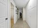 Hallway with a tile floor, leading towards a living space at 42760 W Magnolia Rd, Maricopa, AZ 85138