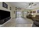 Comfortable living room with reclining furniture and sliding glass doors leading to the backyard at 42760 W Magnolia Rd, Maricopa, AZ 85138