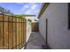 Outdoor space with a gated area and walkway on the side of the home at 42760 W Magnolia Rd, Maricopa, AZ 85138