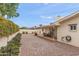This backyard features gravel landscaping, covered patio and manicured shrubs and bushes at 4306 E Dragoon Cir, Mesa, AZ 85206