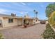 Backyard view of covered patio, rock landscaping, mature hedges and painted block wall at 4306 E Dragoon Cir, Mesa, AZ 85206