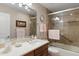 Well-lit bathroom with a glass-enclosed shower, marble vanity, and neutral-toned tiles at 4306 E Dragoon Cir, Mesa, AZ 85206