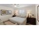 Comfortable bedroom with neutral tones, featuring a window with shutters and classic furnishings at 4306 E Dragoon Cir, Mesa, AZ 85206