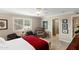 Bright bedroom with comfortable seating area, tile floors, and a view to the Primary bath at 4306 E Dragoon Cir, Mesa, AZ 85206