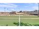 Outdoor bocce ball court featuring a pristine green surface and spectator benches for relaxing outdoor play at 4306 E Dragoon Cir, Mesa, AZ 85206