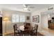 Formal dining room with wood table, upholstered chairs, shuttered window, and a ceiling fan at 4306 E Dragoon Cir, Mesa, AZ 85206