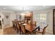 Formal dining room featuring large wood table, upholstered chairs, and a brick fireplace at 4306 E Dragoon Cir, Mesa, AZ 85206