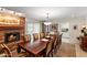 Elegant dining room featuring a brick fireplace and a large wooden table with seating for ten at 4306 E Dragoon Cir, Mesa, AZ 85206