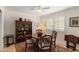 Traditional dining room with a round table, wood chairs, shuttered window, and a classic china cabinet at 4306 E Dragoon Cir, Mesa, AZ 85206