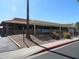 Commercial property featuring a stucco exterior, tiled roof, and a covered patio, offering a welcoming ambiance at 4306 E Dragoon Cir, Mesa, AZ 85206