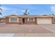 Charming single story brick home featuring manicured desert landscaping and an attached two car garage at 4306 E Dragoon Cir, Mesa, AZ 85206