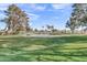 Beautiful golf course view features a scenic pond, lush green grass, and mature trees at 4306 E Dragoon Cir, Mesa, AZ 85206