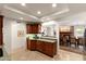 Spacious kitchen featuring granite countertops, custom cabinets, and open access to the breakfast nook at 4306 E Dragoon Cir, Mesa, AZ 85206