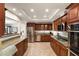 Modern kitchen with granite countertops, stainless steel appliances, and elegant wooden cabinetry at 4306 E Dragoon Cir, Mesa, AZ 85206