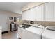 A convenient laundry room with granite countertops, sink, storage cabinets, and modern washer and dryer at 4306 E Dragoon Cir, Mesa, AZ 85206