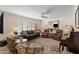 Inviting living room with neutral tones, comfortable seating, shuttered windows, and a ceiling fan at 4306 E Dragoon Cir, Mesa, AZ 85206