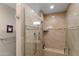 Luxurious tiled shower with built-in seat, and glass enclosure at 4306 E Dragoon Cir, Mesa, AZ 85206
