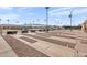 Outdoor shuffleboard court with multiple lanes and spectator seating, perfect for friendly competition and recreation at 4306 E Dragoon Cir, Mesa, AZ 85206