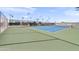 Well maintained tennis court with palm trees in the background at 4306 E Dragoon Cir, Mesa, AZ 85206