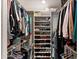 Organized walk-in closet with shelves and hanging racks for clothing and shoes at 4306 E Dragoon Cir, Mesa, AZ 85206