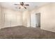Bright bedroom offering a ceiling fan, carpet flooring and a closet with sliding doors at 4335 E Sleighbell Dr, Gilbert, AZ 85297
