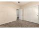 Neutral bedroom featuring carpet floors, a ceiling fan, and large closet doors at 4335 E Sleighbell Dr, Gilbert, AZ 85297