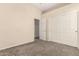 Spacious bedroom with neutral carpet and access to the bathroom and a closet at 4335 E Sleighbell Dr, Gilbert, AZ 85297
