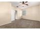 Bedroom showcasing a ceiling fan, carpet flooring, and natural light from a window at 4335 E Sleighbell Dr, Gilbert, AZ 85297