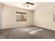 Bright bedroom featuring a ceiling fan, window with blinds, and neutral carpeting at 4335 E Sleighbell Dr, Gilbert, AZ 85297