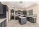 Modern kitchen features dark cabinets, stainless appliances, backsplash, and an island at 4335 E Sleighbell Dr, Gilbert, AZ 85297