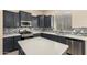 Modern kitchen features dark cabinets, stainless appliances, backsplash, and an island at 4335 E Sleighbell Dr, Gilbert, AZ 85297