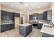 Modern kitchen features dark cabinets, stainless appliances, backsplash, and an island at 4335 E Sleighbell Dr, Gilbert, AZ 85297