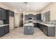 Modern kitchen features dark cabinets, stainless appliances, backsplash, and an island at 4335 E Sleighbell Dr, Gilbert, AZ 85297