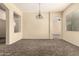 Bright carpeted living room with neutral walls, arched openings, and an elegant chandelier, perfect for gatherings at 4335 E Sleighbell Dr, Gilbert, AZ 85297