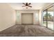 Bright living room features neutral walls, plush carpet, and sliding glass door at 4335 E Sleighbell Dr, Gilbert, AZ 85297