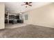 Bright living room connected to the kitchen with hardwood floors and a ceiling fan at 4335 E Sleighbell Dr, Gilbert, AZ 85297